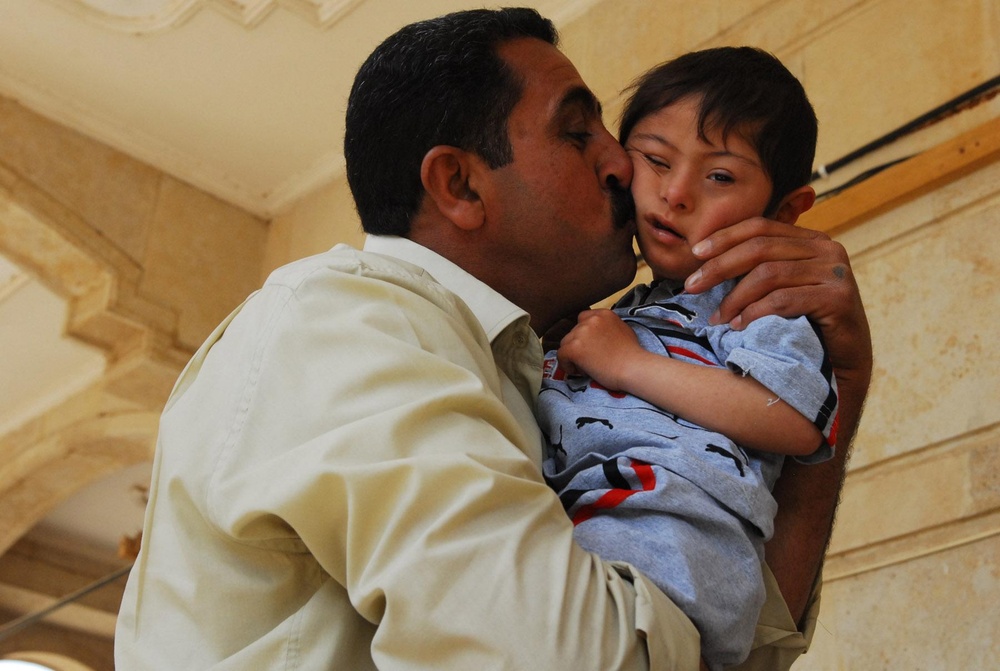 Vanguard Brigade Soldiers help distribute wheelchairs to disabled Iraqi children