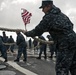 Seaman Brian Crawford takes in mooring line four as USS Forrest Sherman gets underway.
