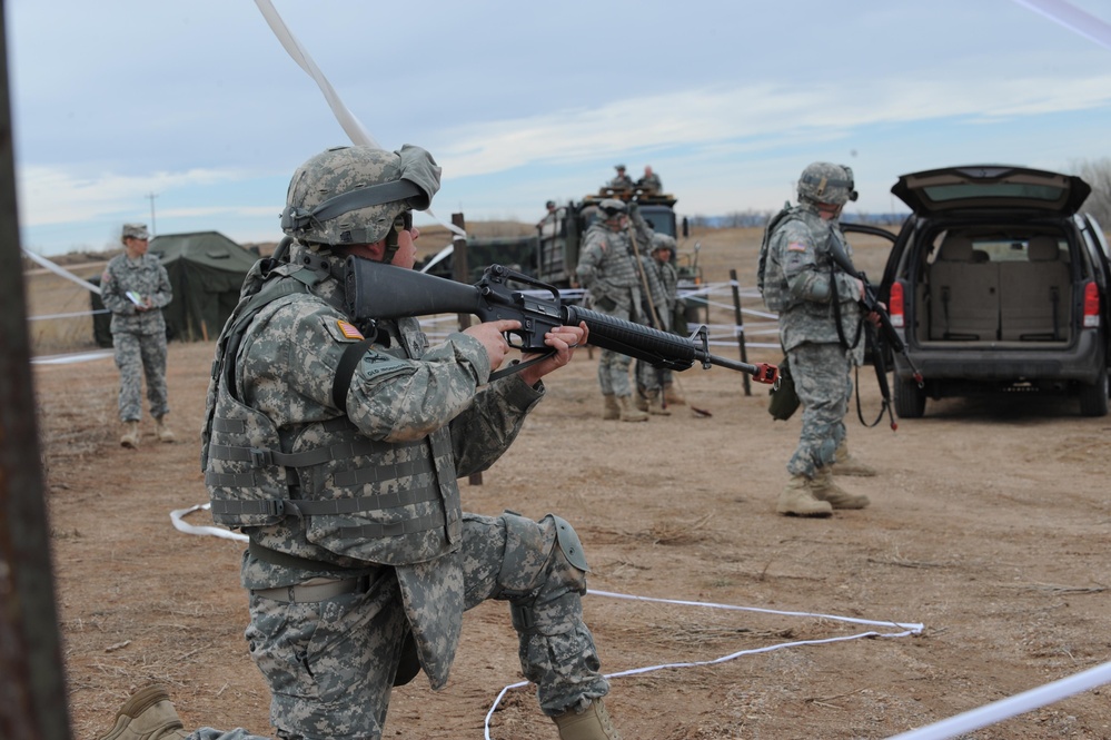 Soldiers with the South Dakota Army National Guard's 842nd Engineer Company maintain security while conducting an Entry Control Point training scenario