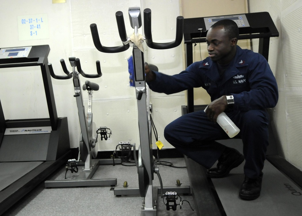 USS Tortuga Sailor Cleans Gym