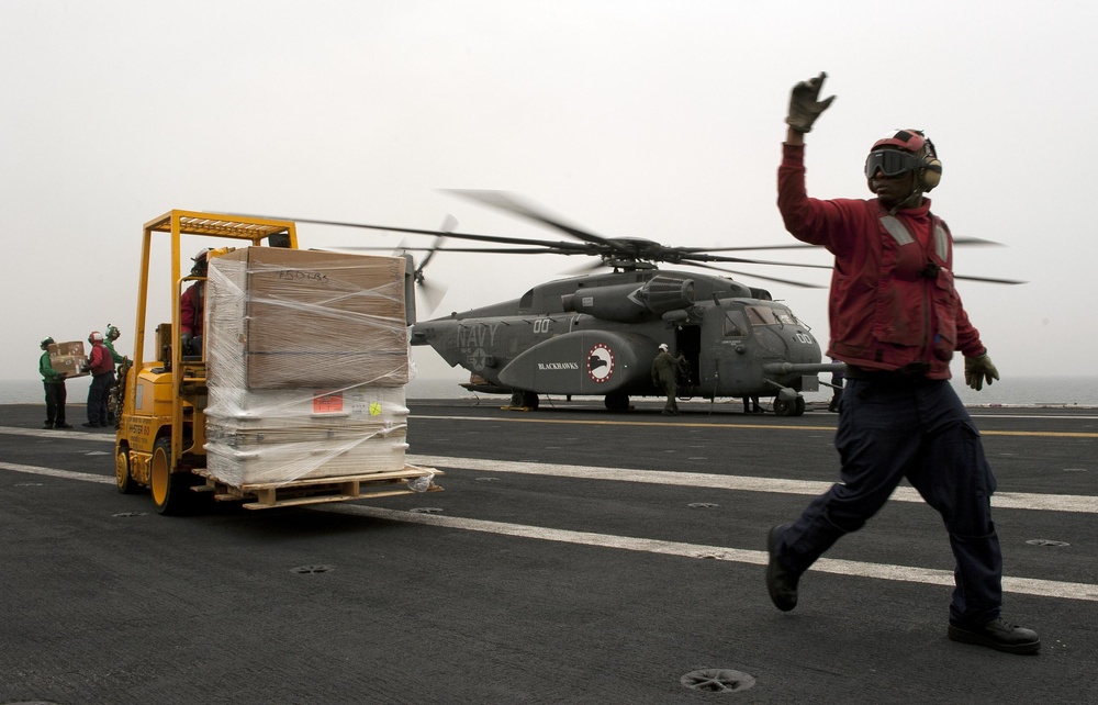 Sailors Unload Supplies Aboard the USS Carl Vinson