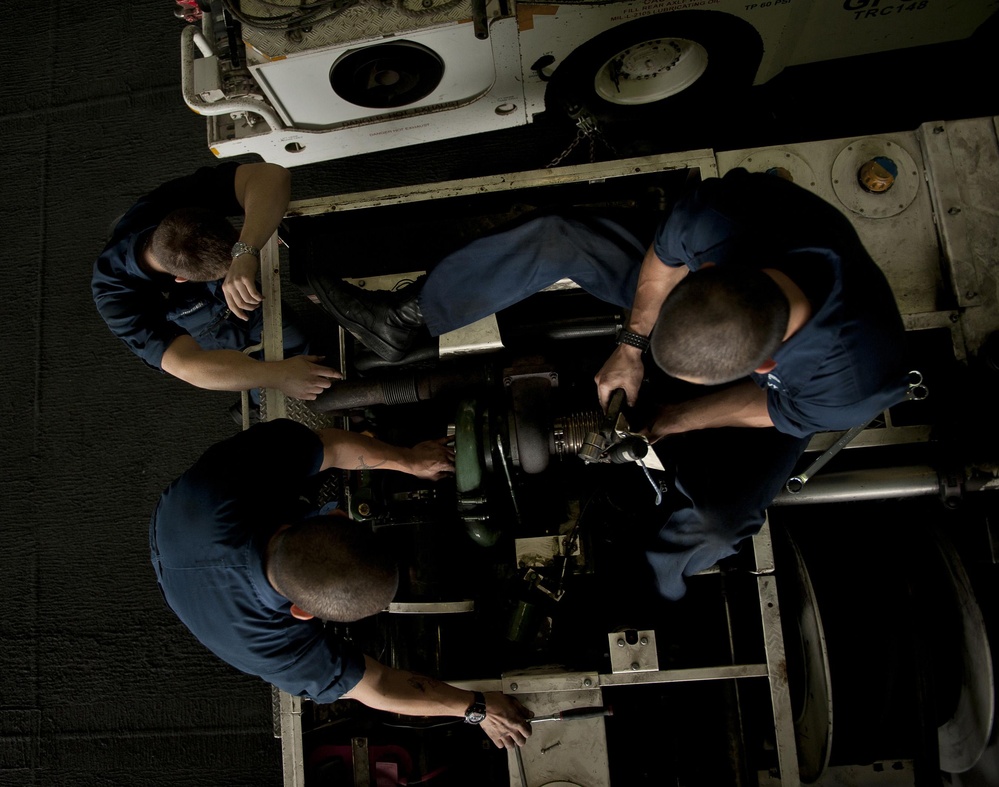 USS Carl Vinson Sailors Work on a P-25 Truck