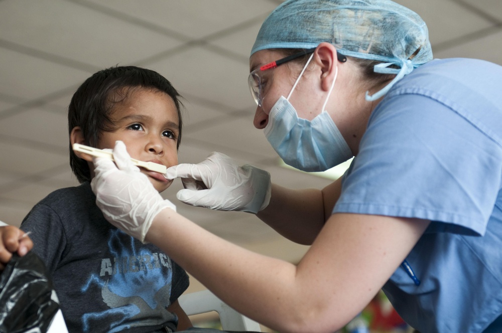 Airman teachers a Salvadoran boy how to use a toothbrush during 'Beyond the Horizon 2011'