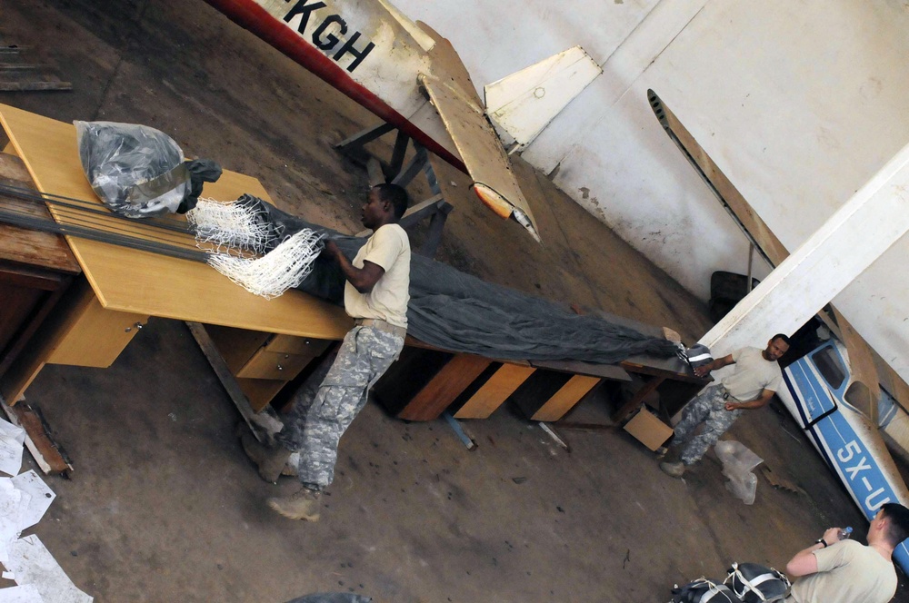 AD 11 riggers prep chutes in tough conditions; train with Ugandans on aerial resupply