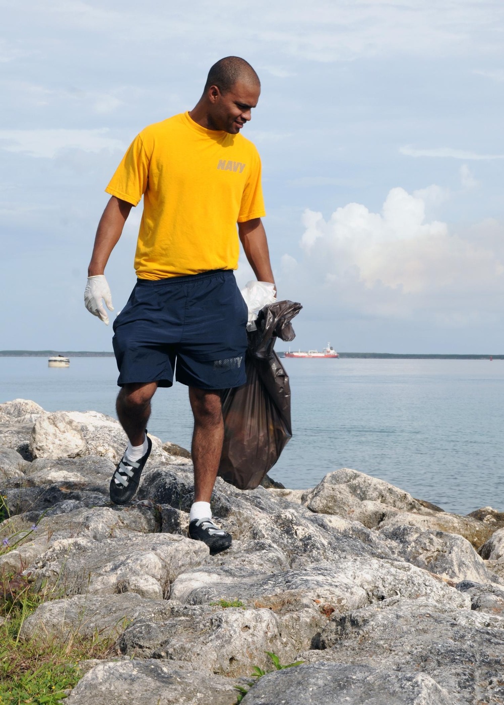 USS Frank Cable Sailor Looks For Litter on Earth Day