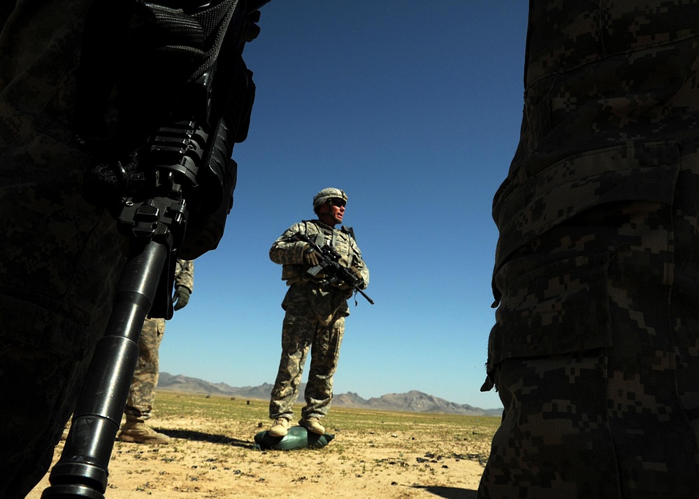 US Soldiers familiarize themselves with their weapons before missions.