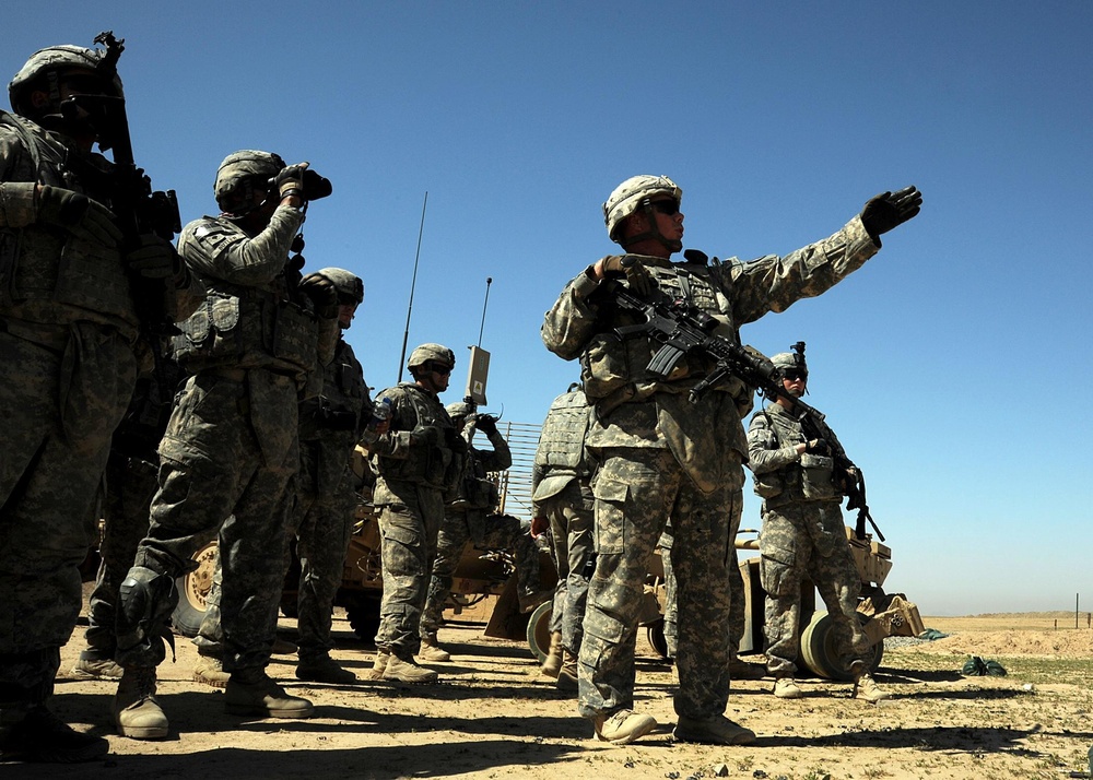 US Soldiers familiarize themselves with their weapons before missions.