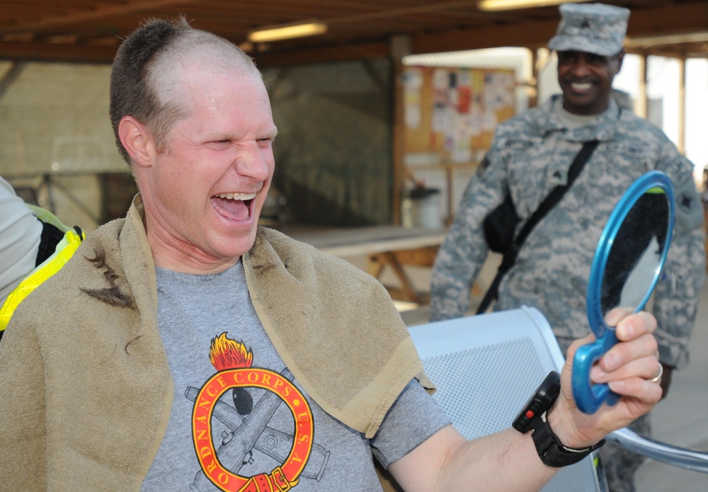 Going bald for UK cancer research at Kandahar Airfield, Afghanistan