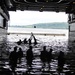 Sailors play football in USS Cleveland's well deck