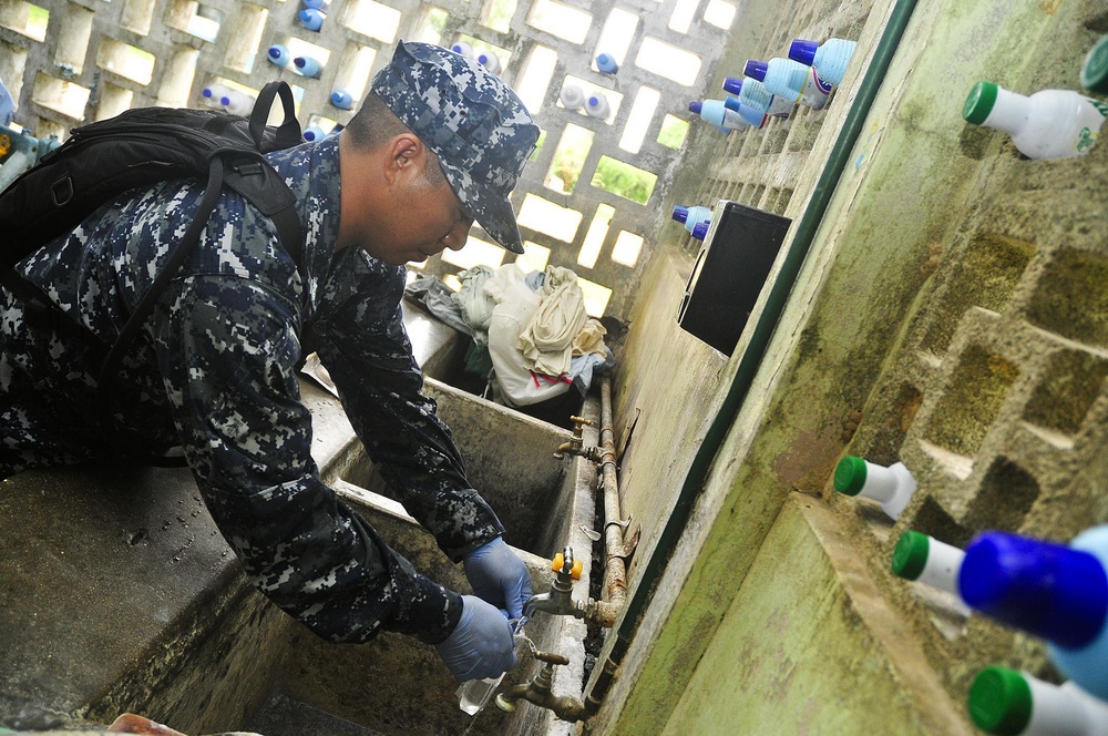 Sailor takes water sample in Vanuatu