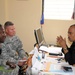 Louisana Guardsman, Col. Kenneth Donnelly, commander Task Force Bon Voizen, discusses task force missions with the director-general of the Artibonite police department.