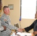 Col. Kenneth Donnelly, commander Task Force Bon Voizen, shakes hands with the director-general of the Artibonite police department