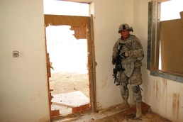 Engineers and infantrymen train together on how to secure a compound at Camp Taji, Iraq