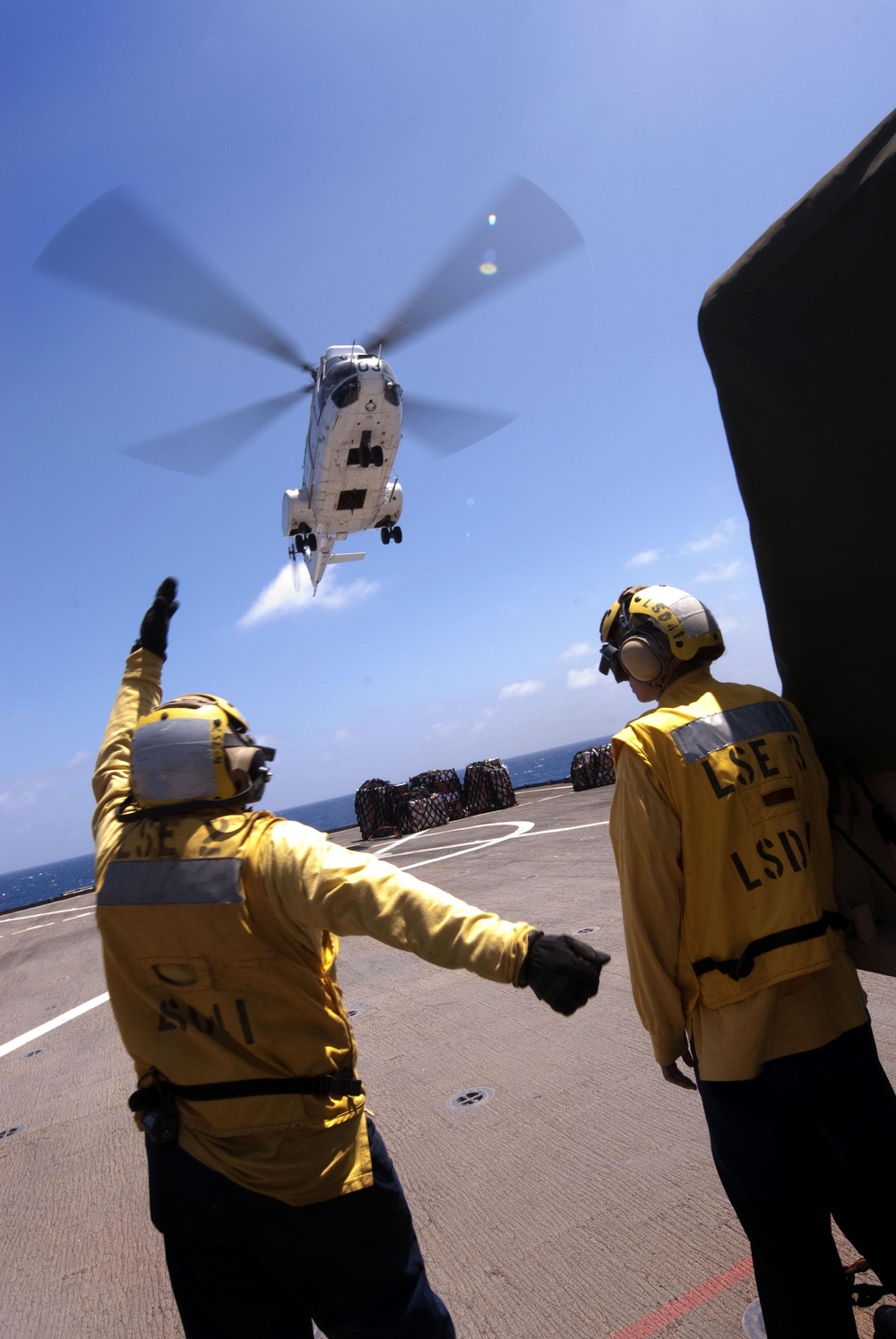 USS Whidbey Island sailor directs Puma helicopter