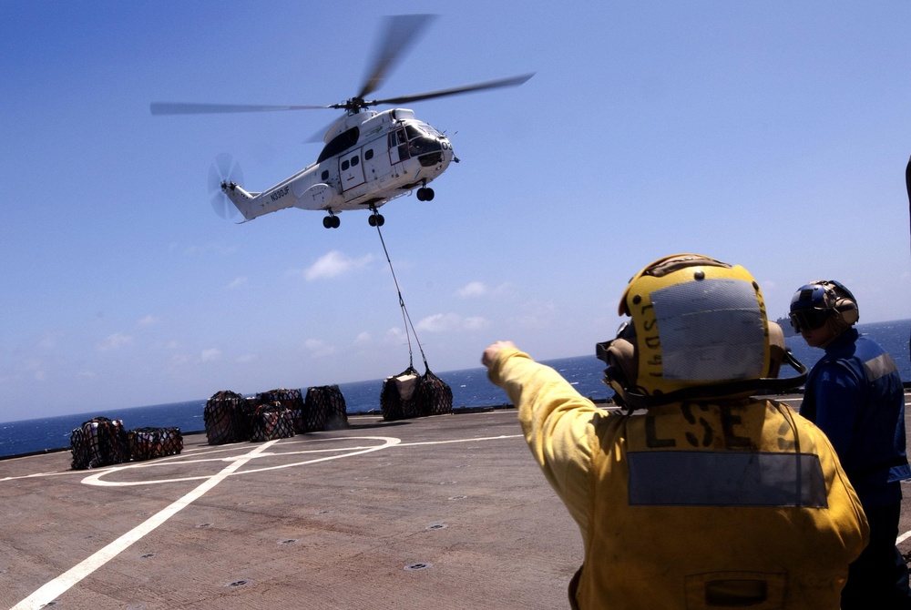 USS Whidbey Island sailor directs Puma helicopter