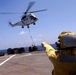 USS Whidbey Island sailor directs Puma helicopter