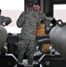 Bombs away: Airmen work together to build, load munitions