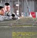 Bombs away: Airmen work together to build, load munitions