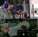 Bombs away: Airmen work together to build, load munitions