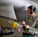 Bombs away: Airmen work together to build, load munitions