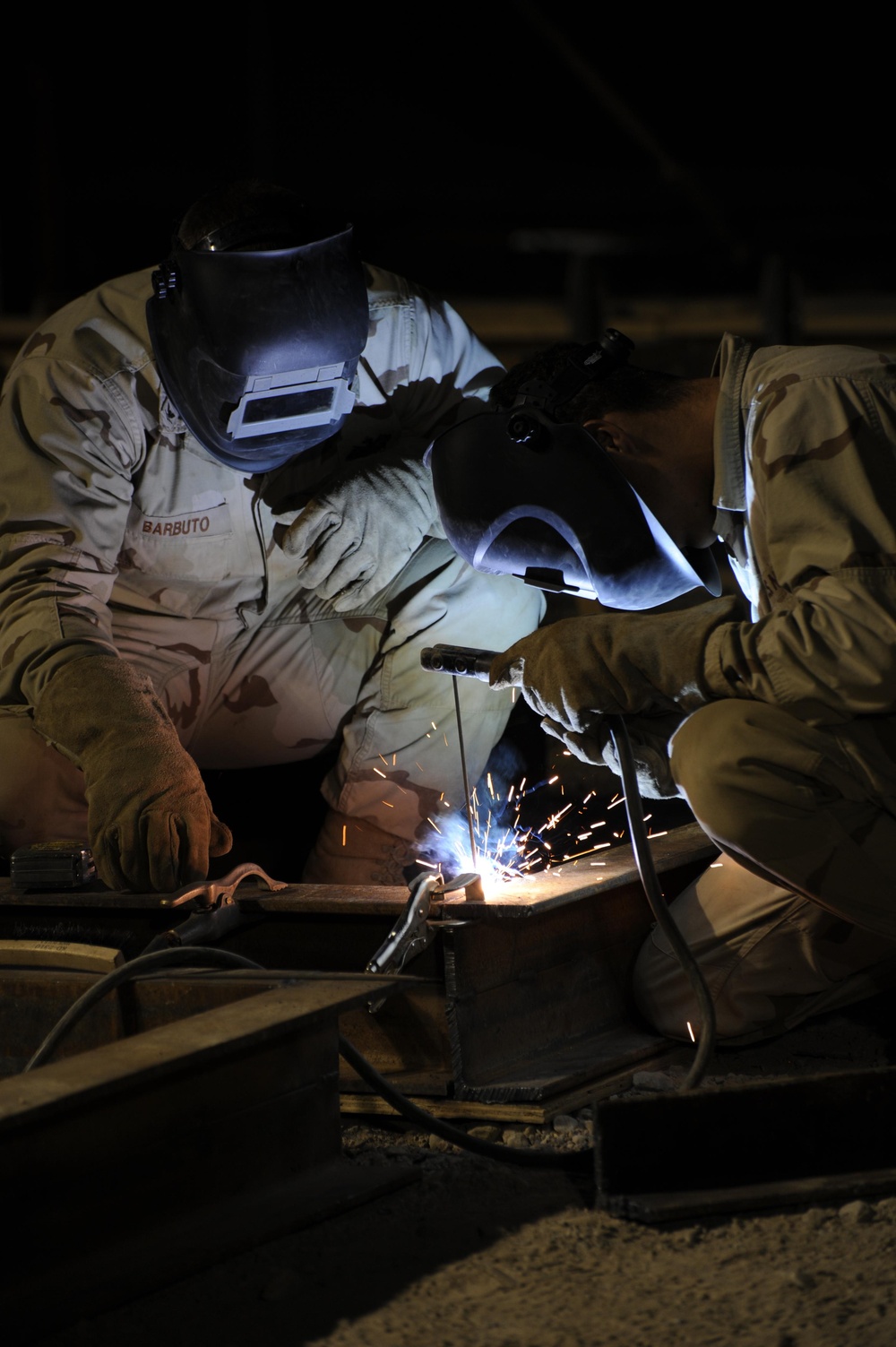 Seabees welding at night to beat the heat