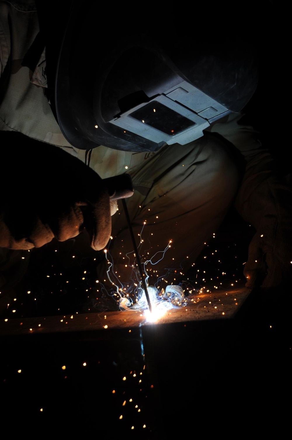 Seabee welding a frame together