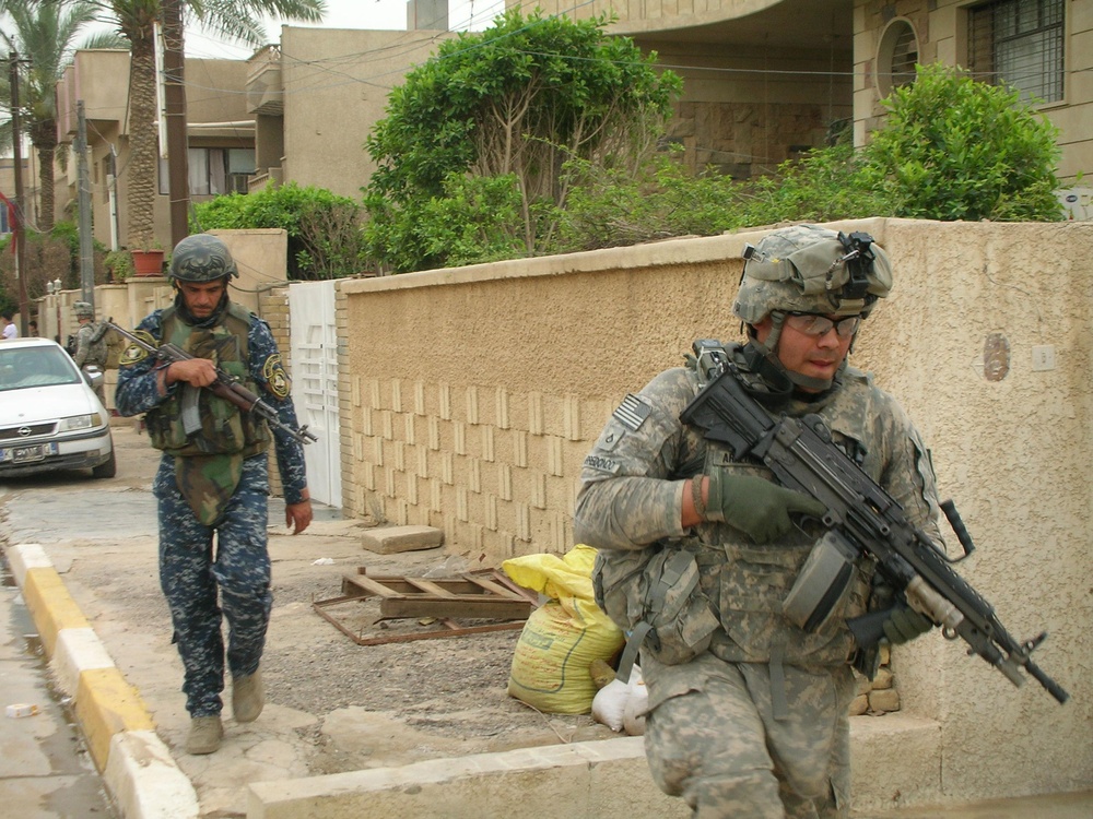 ‘First Lightning’ Battalion soldiers conduct a combined patrol with 1st Iraqi Federal Police partners