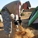 Soldier digs trench around his tent