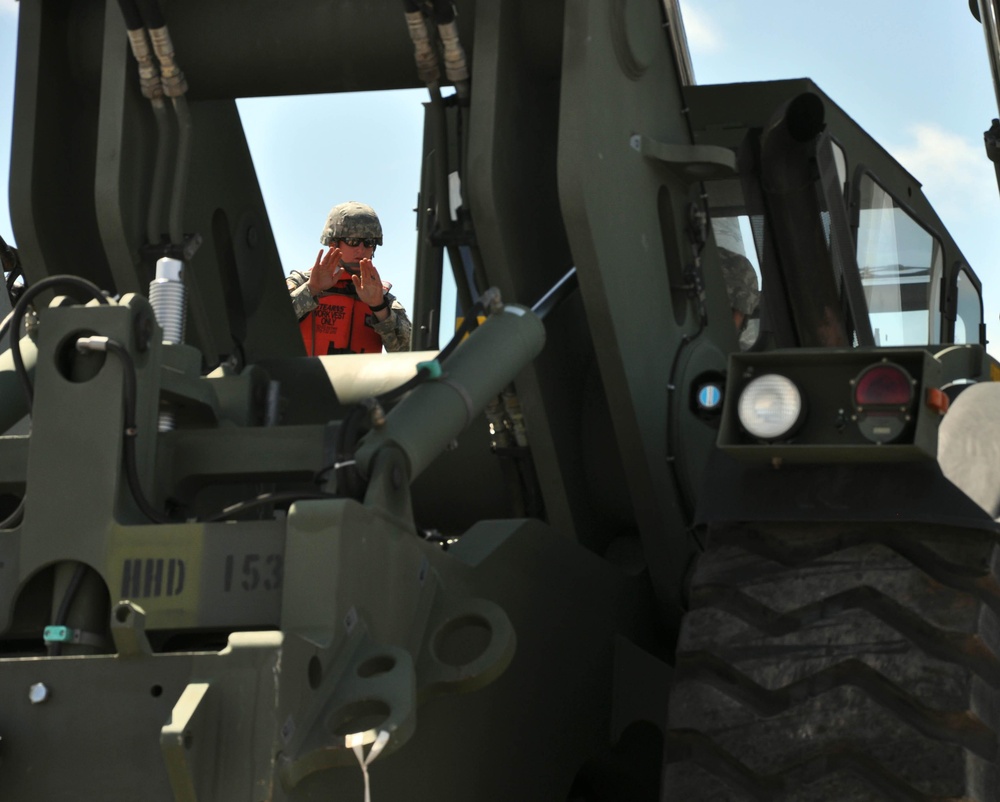 Soldier guides a Kalmar Rough Terrain Cargo Handler