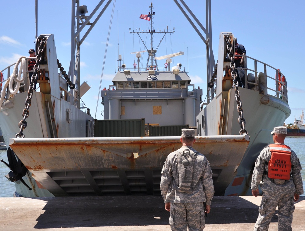 Soldiers watch as Vessel's ramp is lowered