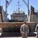 Soldiers watch as Vessel's ramp is lowered