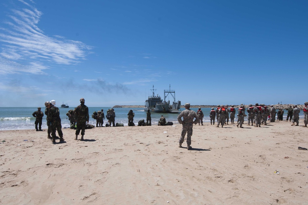 Service members wait for Army Landing Craft Utility (LCU) 2006