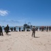 Service members wait for Army Landing Craft Utility (LCU) 2006