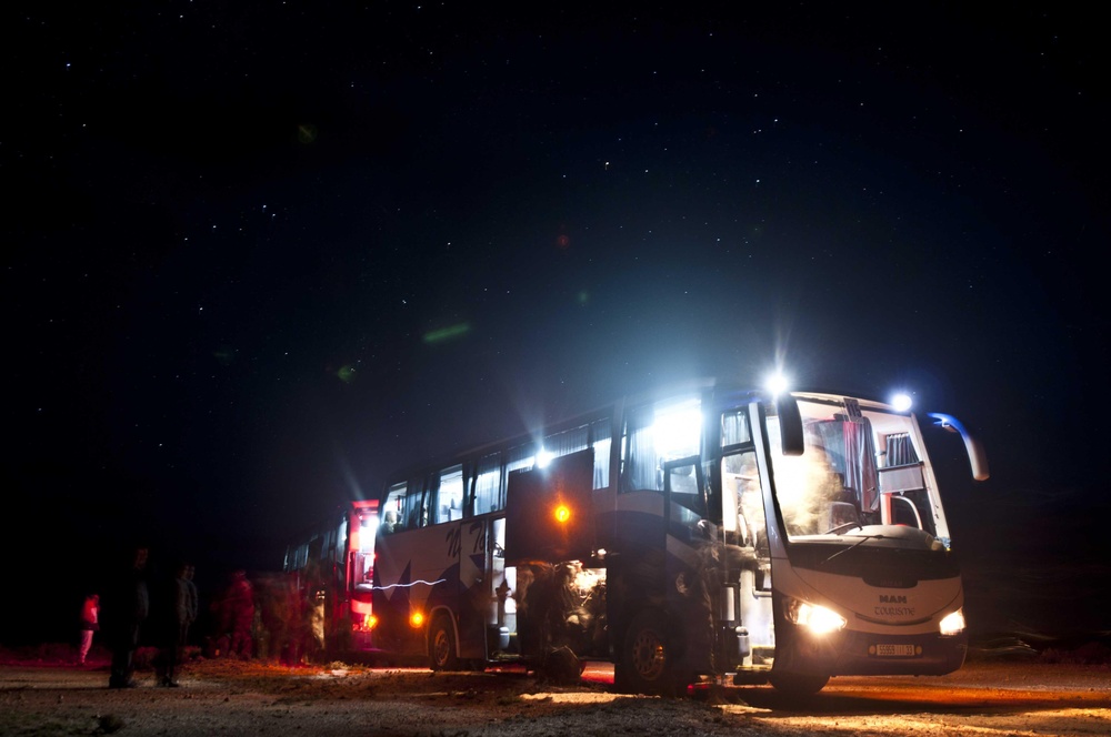 Service members supporting African Lion boards bus