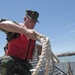 Seaman casts off a Landing Craft Mechanized (LCM) 847