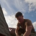 Seabee hammers tent stake at JLOTS base camp