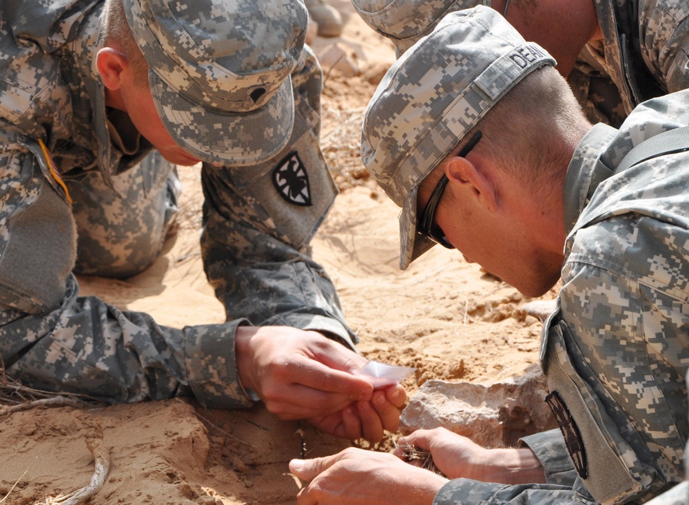 A soldier builds a fire during survival training