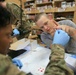 U.S. Army Medics train in applying intravenous solution on mock patients
