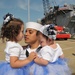 Seaman Jonathan Vargas holds his daughters during the amphibious assault ship USS Kearsarge return to Naval Station Norfolk