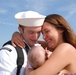 Seaman Roberto Valentine holds his daughter for the first time during the amphibious assault ship USS Kearsarge return to Naval Station Norfolk