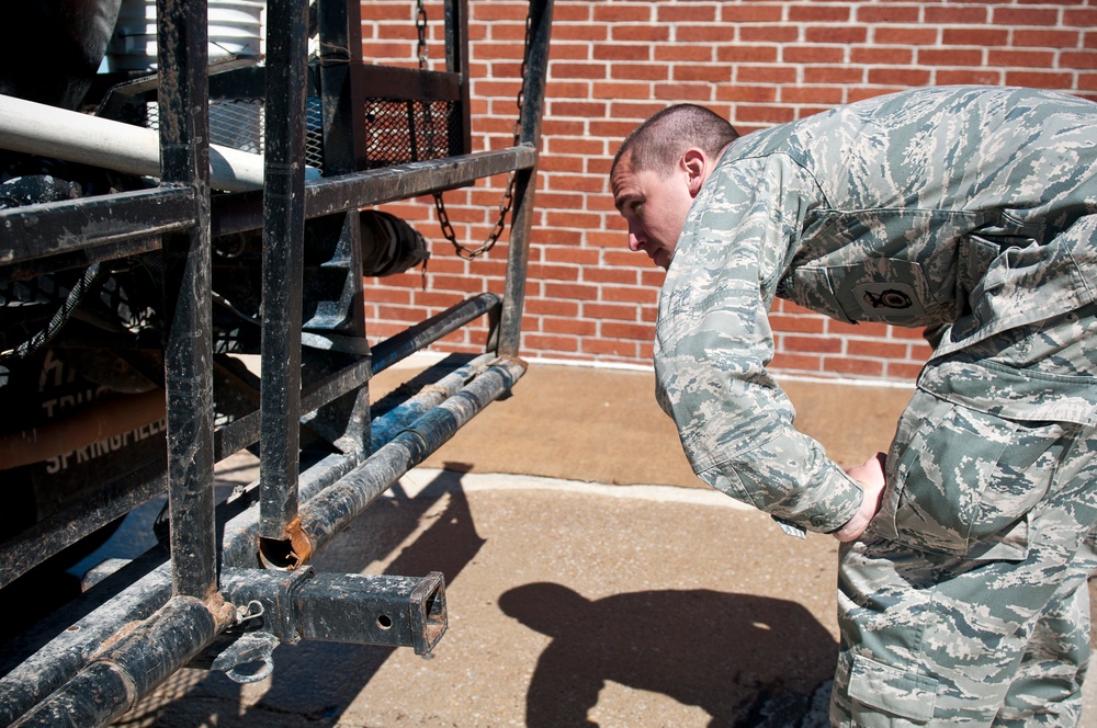 Airman 1st Class Mike Watts with the 123rd Security Forces inspects a truck at the entry control point before allowing access to the flight line in Springfield, MO on May 16, 2011 during the National Level Exercise.