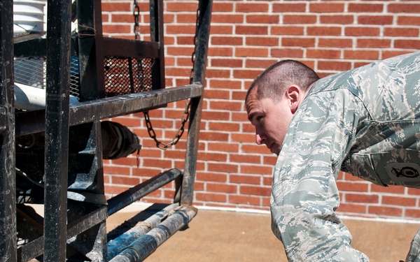Airman 1st Class Mike Watts with the 123rd Security Forces inspects a truck at the entry control point before allowing access to the flight line in Springfield, MO on May 16, 2011 during the National Level Exercise.