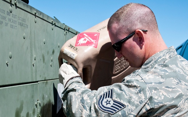 Tech. Sgt. Rob Shipp with the 123rd Contingency Response Element pours gasoline into the generator that gives power to the Hard sided Expandable Light Air Mobile Shelter, HELAMS, on May 16, 2011 in Springfield, MO.
