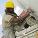 US Soldier applies plaster to latrine wall