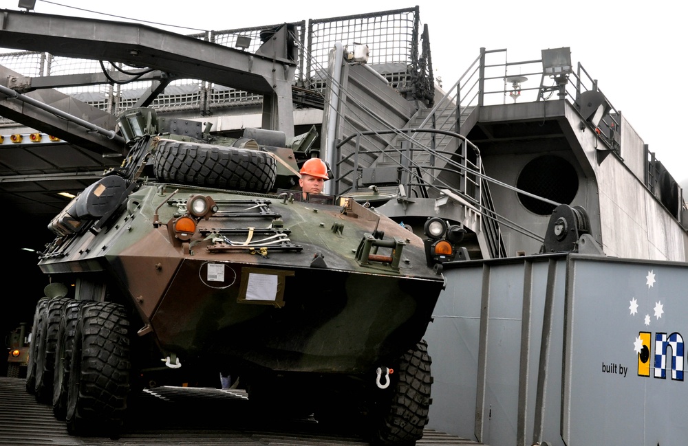 Service members unload equipment in port operation