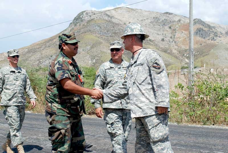 Louisiana Guardsman, Maj. Larry Benton, a member of Task Force Bon Voizen, welcomes Brig. Gen. Tapia, commander of the Belize Defence Force