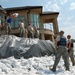 Soldiers and airmen work to reinforce levee