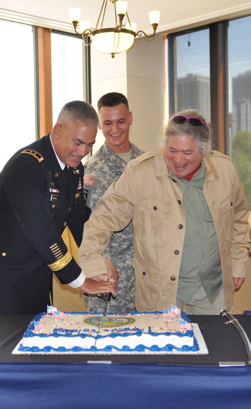 Maj. Gen. Campbell, Sgt. Carter and Col. (Ret.) Jim Prtizker cut the 236th Army Birthday cake