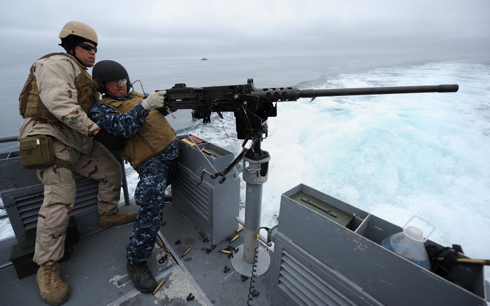 Sailors fire machine gun during Shark Tank 2011