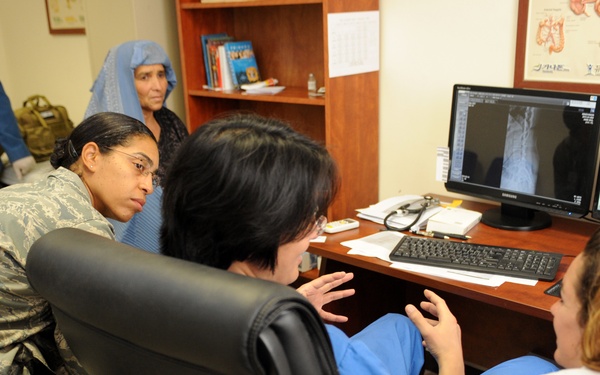 Members of FTT and a doctor look over patient's records